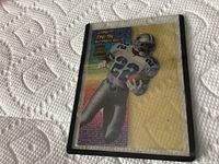 Front of Emmitt Smith collectible football card with player image in Dallas Cowboys uniform and colorful background pattern.