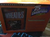Photo of closed commemorative box with Wheaties branding and 75 Years of Champions logo, showing general packaging design