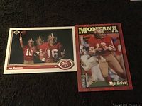 Two Joe Montana football collectible cards side by side on a dark surface.