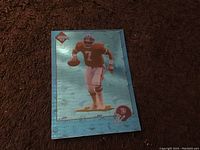 Front view of the 1993 Edge collectible football card of John Elway showing his image and holographic background.