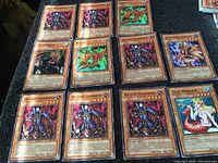 Image showing 12 Yu-Gi-Oh cards laid out including Decayed Commander (multiple), Union Rider, Kise, Curse Mermaid, Megarock Paladin.