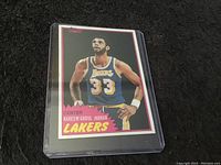Front view of the 1981 Topps Kareem Abdul-Jabbar basketball card in plastic protective sleeve showing player image and team information.