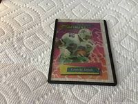 Photo of the front of a 1995 Topps Finest Emmitt Smith football trading card in a protective sleeve, showing the colorful design and player image.