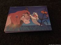 Photo of The Lion King card showing Simba and Rafiki characters in a colorful animation style