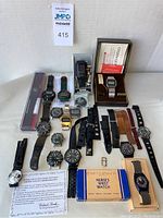 Full lot overview showing watches, straps, boxes and certificate