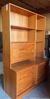 Full front view of assembled teak cabinet and bookshelf.