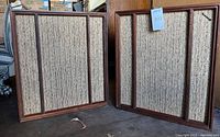 Pair of Wharfedale W70 speakers showing front fabric grilles with wooden framing and beige textured fabric.