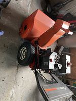 Side view of engine, control panel and treaded tire