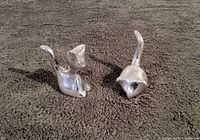 Pair of vintage Hoselton aluminum cat and mouse ring holder sculptures, shown side by side on a dark textured surface.