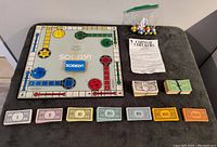 Overview of Sorry game board with sliders, assorted game money laid out