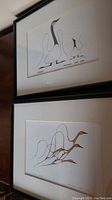Both framed prints showing stylized bird artwork by Benjamin Chee Chee with neat matting and black frames.