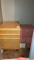 Filing cabinet and bathroom storage unit placed side by side in a corner, showing overall condition and size relationship.