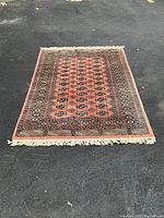 Full view of rug laid flat on asphalt surface