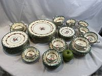 Wide view of entire lot on white backdrop with green apple for scale