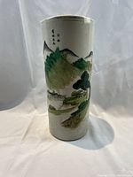 Front view of cylindrical porcelain brush vase with landscape painting
