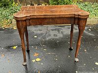 Full front view of the mahogany games table on driveway