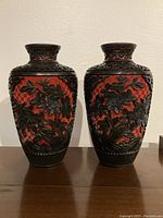 Front view of pair showing carved floral panels