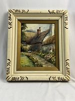 Full view of framed watercolor painting of English cottage by J. Geldard Walton