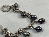 Close-up of sterling silver link chain with Tahitian pearl drops