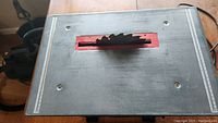 Full view of the table saw work surface with visible circular saw blade and measurement markings on sides.