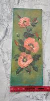 Full view of rectangular canvas board painting of poppy flowers with a red ruler showing length around 18 inches.