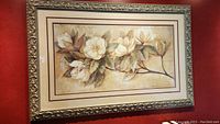 Front view of the framed floral print showing cream flowers on branch with detailed frame.