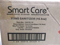 Close-up of the Smart Care branded box label indicating hand sanitizer, 16.9 oz, quantity 12 units, lot and expiration date 05/2022.