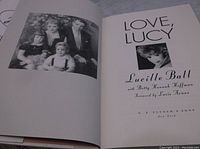 Open pages of 'Love, Lucy' book showing title and black-and-white photo