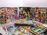 Photo showing colorful covers of vintage comics including The Crusaders and Marvel Superheroes, some bagged and boarded.
