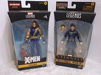 Front view of Marvel Legends packaged figures of X-Men Cyclops and Eternals Ikaris, showing figures and accessories.