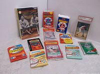 Photo showing entire lot including various sealed baseball card packs spread out around one graded baseball card and the Ballstreet Journal magazine