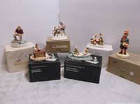 Lot of six Sebastian Miniatures figurines mostly on box stands, showing their various scenes and subjects.
