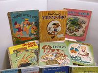 Photo of six Little Golden Books, including titles 'Three Little Pigs', 'Pinocchio', 'Duffy the Tugboat', 'Noah's Ark', 'The Battle Golden Book of Dogs', and 'Hansel and Gretel'. Colorful illustrated covers, vintage condition.
