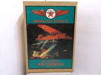Original box featuring artwork and branding of the 1929 Lockheed Air Express plane bank by Wings of Texaco.