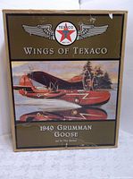 Front of the original box with Texaco Wings of Texaco branding and artwork of the 1940 Grumman Goose amphibious airplane.