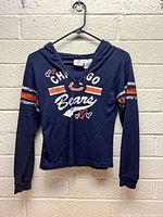 Front view of navy blue hooded long sleeve shirt with Chicago Bears graphics and hearts