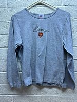 Front view of grey long sleeve women's shirt with embroidered Chicago Bears text and logo on chest.