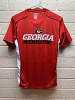 Red Georgia Bulldogs sports shirt front view showing logo and text on chest and white side panels