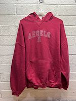 Full front view of red Los Angeles Angels hoodie with embroidered logo and front pocket.