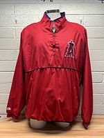 Front view of red Los Angeles Angels pullover with quarter-zip and large team logo patch on chest.