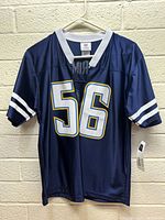 Front view of navy blue Los Angeles Chargers #56 Junior Seau jersey with tags visible on sleeve and neckline.