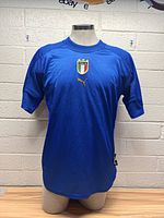 Front view of the blue Italy men's soccer jersey showing crest and Puma logo.