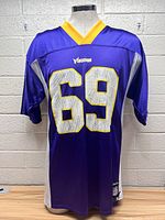 Front view of the Minnesota Vikings Jared Allen #69 purple football jersey with yellow collar and white/yellow accented sleeves.