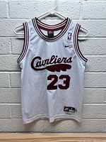 Front view of the white Nike youth basketball jersey with Cleveland Cavaliers logo and LeBron James #23.