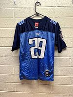 Front view of youth large blue and brown Tennessee Titans jersey with number 29 and Reebok and NFL tags