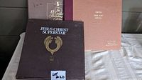 Image shows three classical vinyl album sets laid out on a light colored surface. Albums included are Jesus Christ Superstar, The Greatest Recordings of Cole Porter, and Grieg Peer Gynt Suite No. 1.