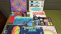 Photo showing various vinyl records with colorful covers, including Bong Dog Band and Fingerling Banjo albums.