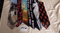 Six novelty neckties laid out on a beige surface, showcasing designs: wolf face, card suits, colorful abstract, barbershop poles, pin-up girl silhouette, and SF Giants logos.