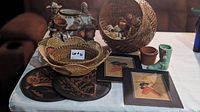 Wide view of the entire lot showing baskets, mini hats, copper plates, framed art, and ceramic boot.