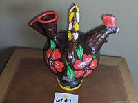 Front angled view of the ceramic water jug shaped like a rooster showing painted red flowers and spout
